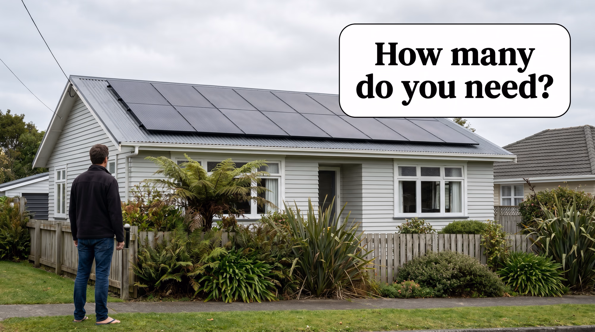 Homeowner looking up at all-black solar panels on a New Zealand weatherboard house roof, speech bubble asking how many do you need