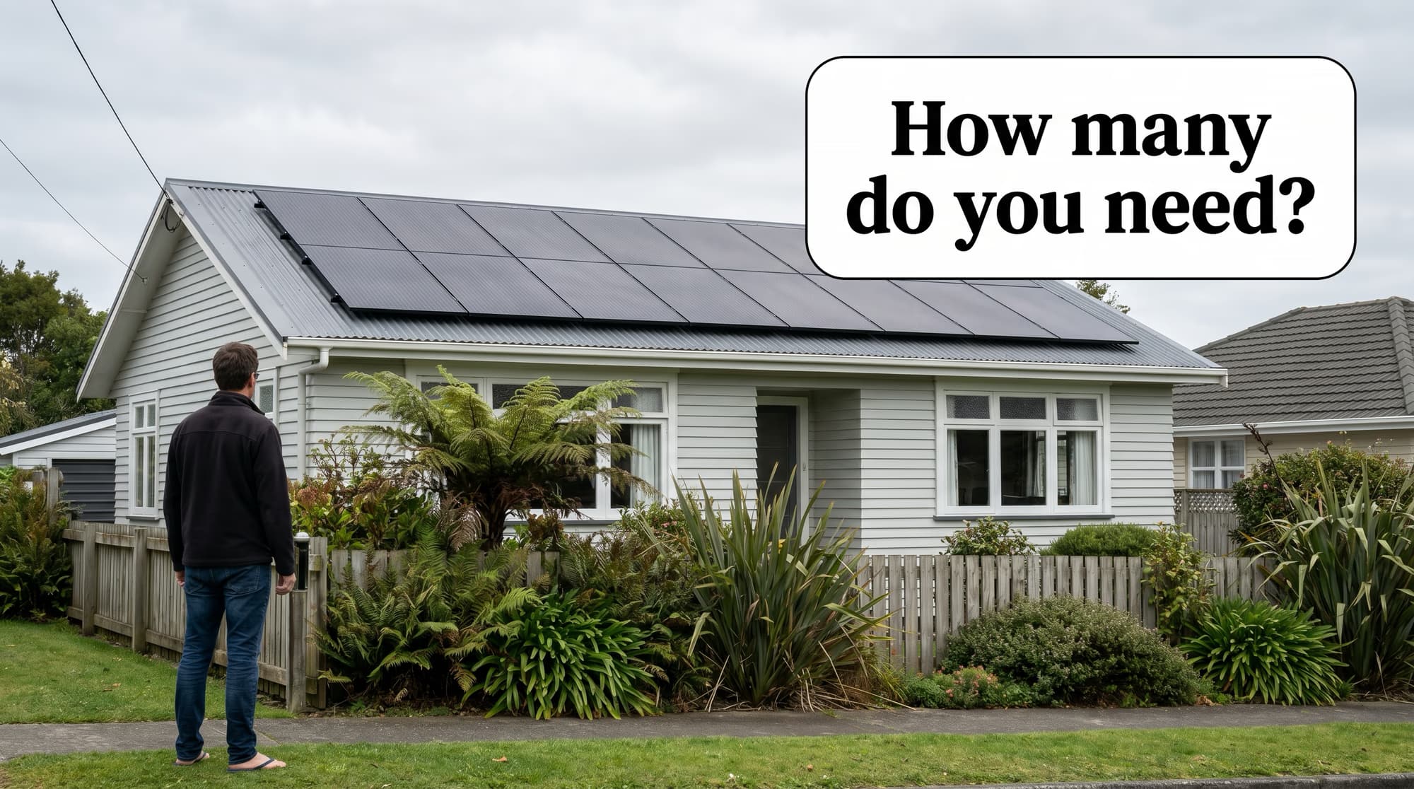 Homeowner looking up at all-black solar panels on a New Zealand weatherboard house roof, speech bubble asking how many do you need