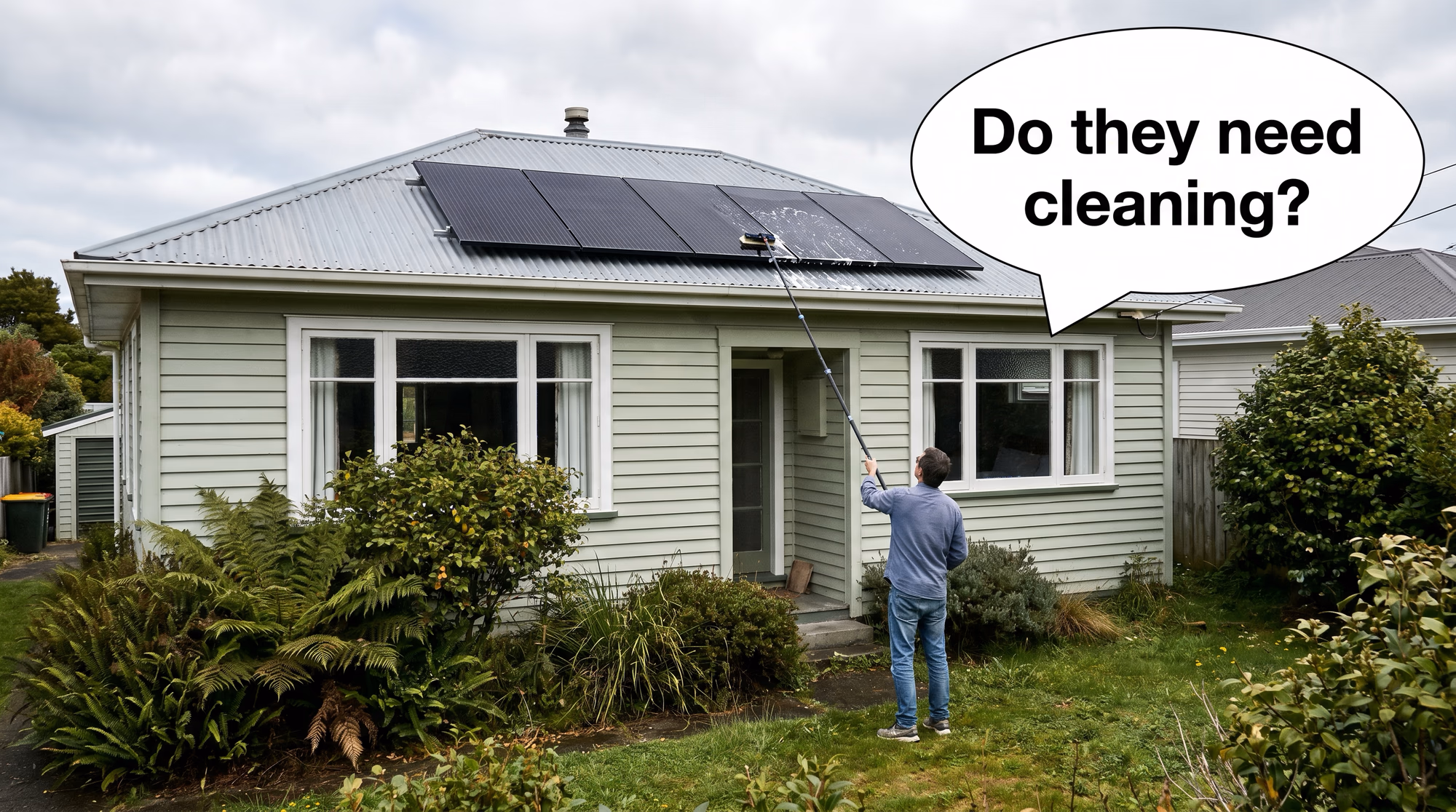 NZ homeowner on the front lawn using a long telescopic water-fed brush to clean all-black solar panels on the roof, speech bubble asking do they need cleaning